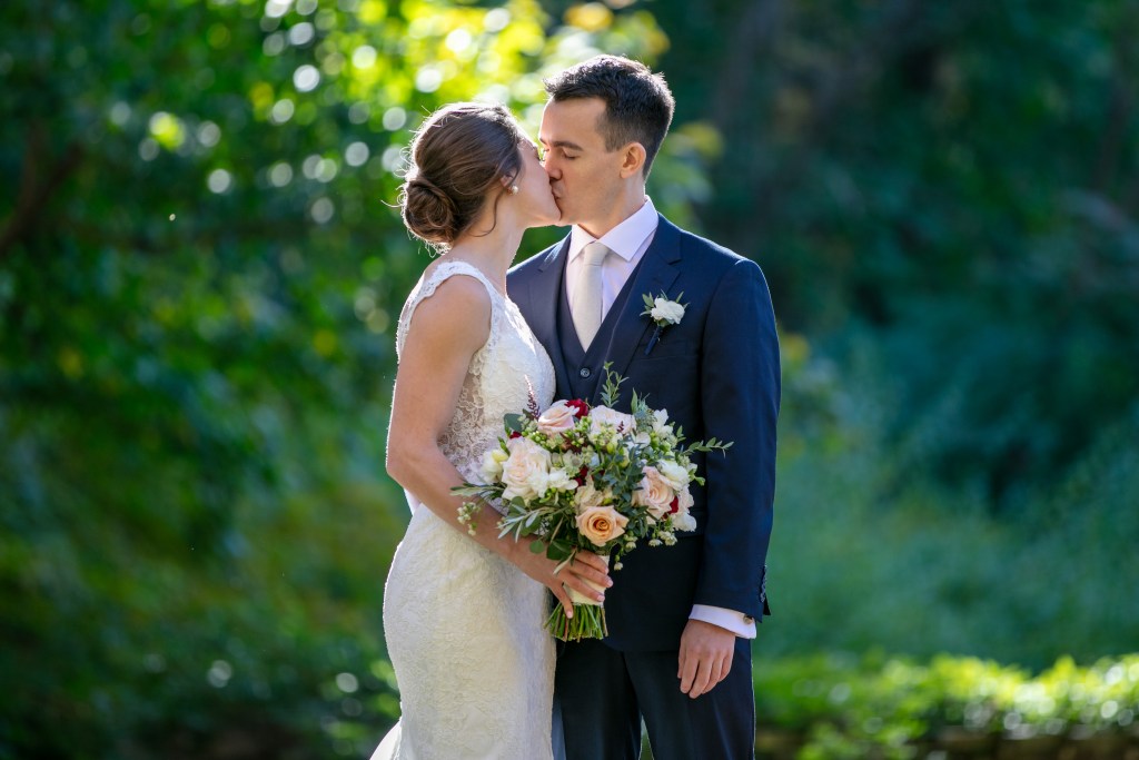 Bride Janina Calabro and groom Jake kissing during their destination wedding at Avon Farms Hotel in Avon, Connecticut. Photo by Hans Gonzalez Photography.
